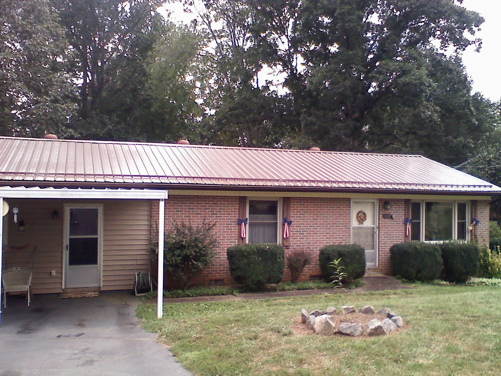 Bronze metal roof and carport on a brick ranch home — Roof Repair work by our crew in Soddy Daisy